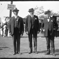 Image of three men standing at the New England Fair