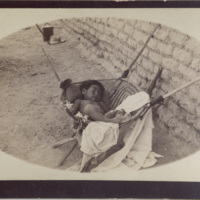 Sleeping baby in woven cradle