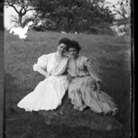 Two women sitting in a field