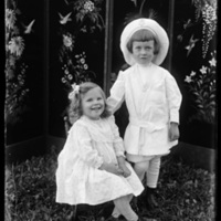 Two young children in front of a screen